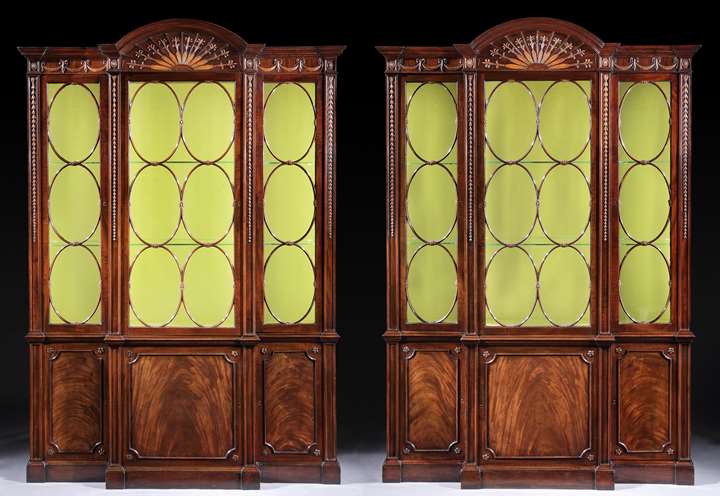 A PAIR OF GEORGE III MAHOGANY AND BOXWOOD BREAKFRONT LIBRARY BOOKCASES IN THE MANNER OF JOHN LINNELL